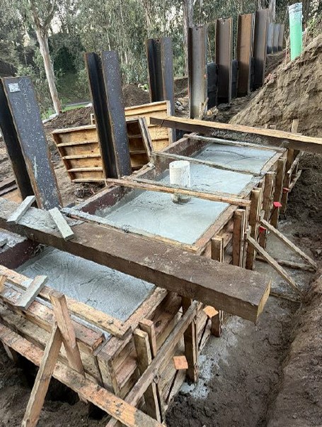 Cement poured at retaining wall to reinforce the structure