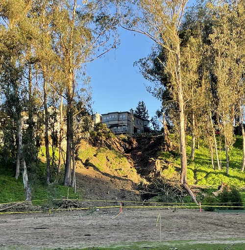 Photo showing washout area on slope from the perspective of the park