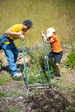 Community members celebrating PODER’s annual corn planting at Mama Earth Day Event in 2023. Photo credit: PODER.