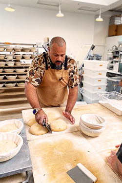 Chef Z cutting and forming the dough for his most delicious sourdough bread.