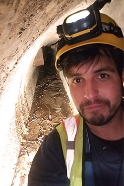 Tim Paez setting in a sewer.