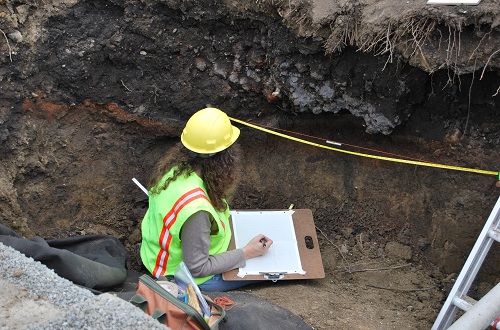 Archaeologist inspecting the hearth