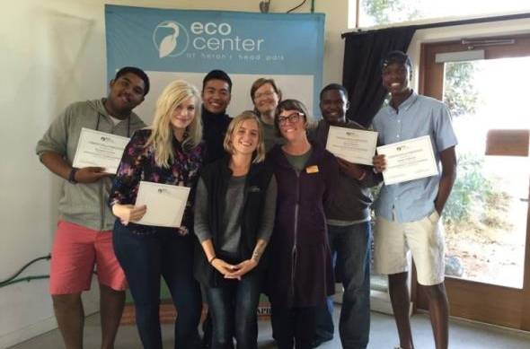 group of recipients holding up award certificates