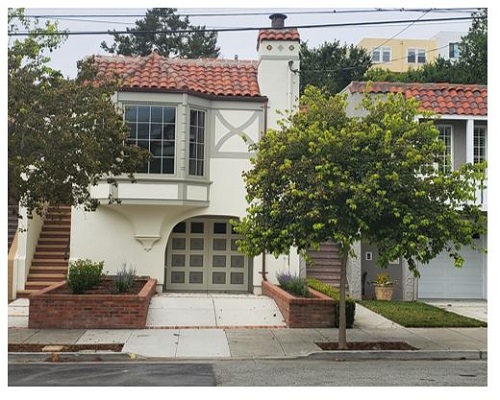 A house with raised planters purchased through the Floodwater Management Grant Program