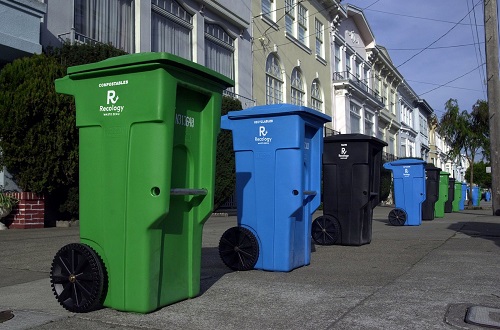 garbage bins on the sidewalk