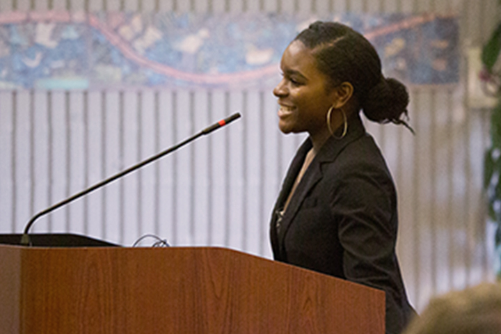 Woman speaking at board meeting