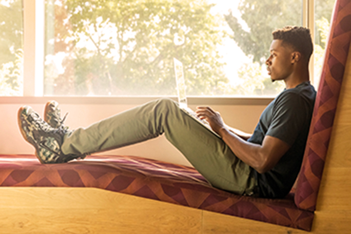 person reading by windowsill