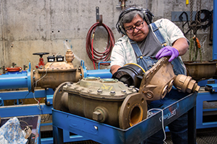 man working on an engine part