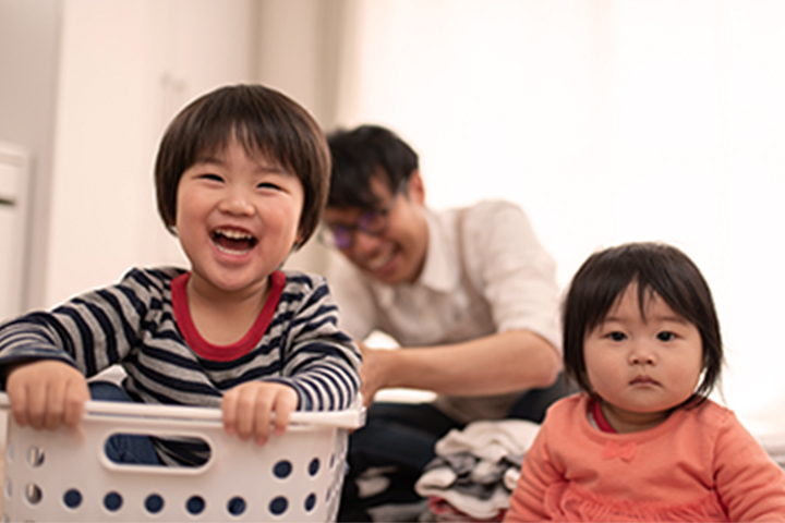 Children playing in the laundry basket.