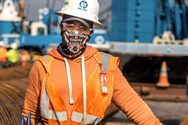 a construction worker wearing protective face covering