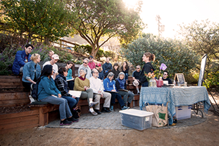 large group assembled upon the steps at the learning garden