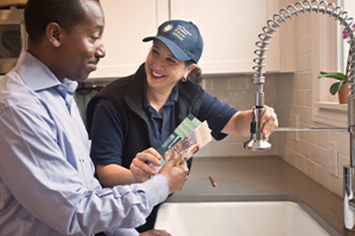 man and woman a sink basin repairing a fixture