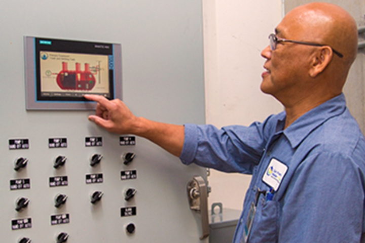 technician using his finger on a control screen