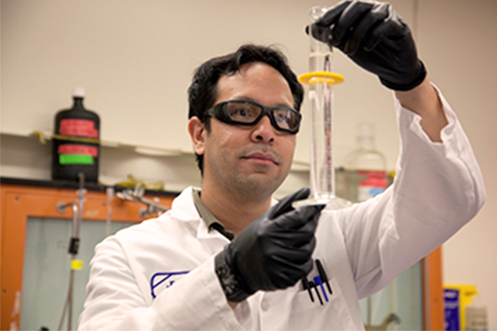 lab technician inspecting a water sample