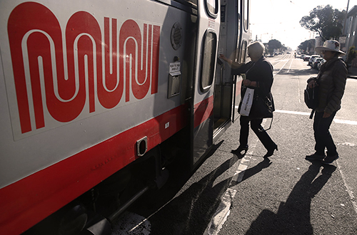 Riders board a MUNI bus.