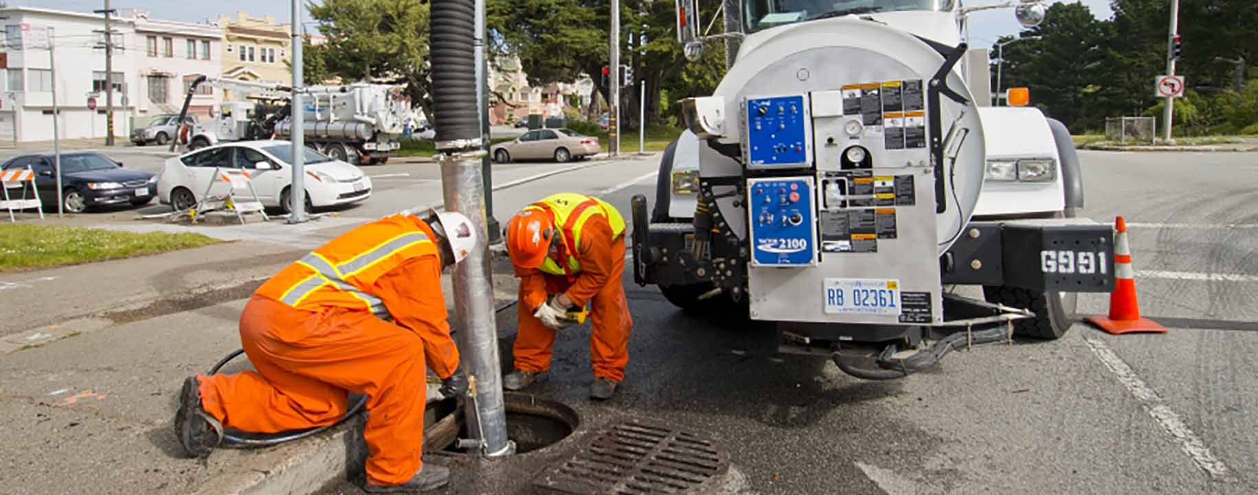 Crews using a vac-con truck to clear storm drains.