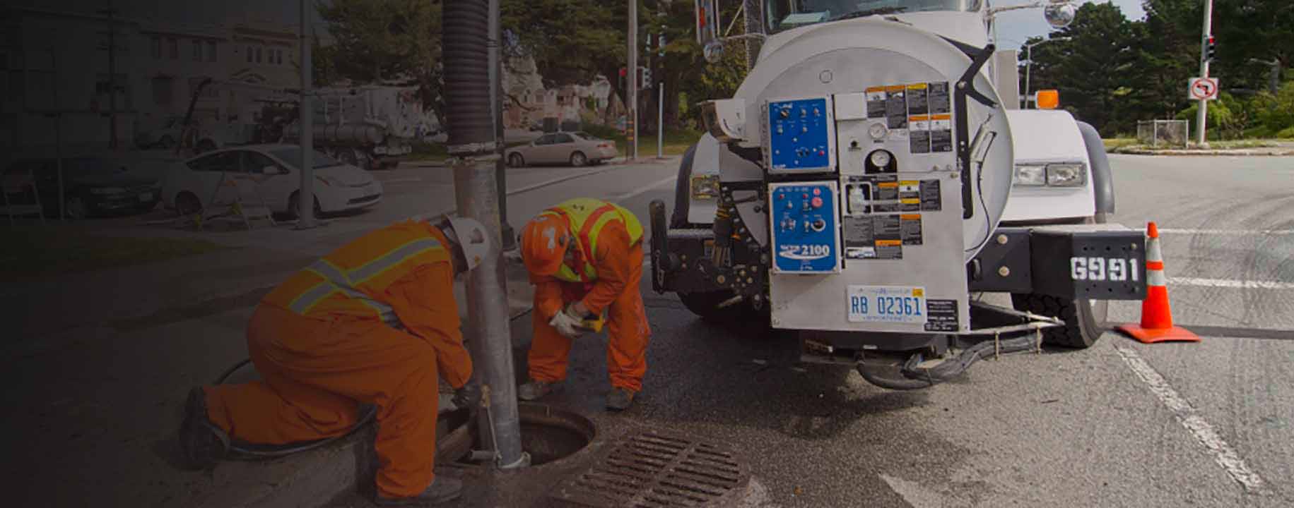 Crews using a vac-con truck to clear storm drains.