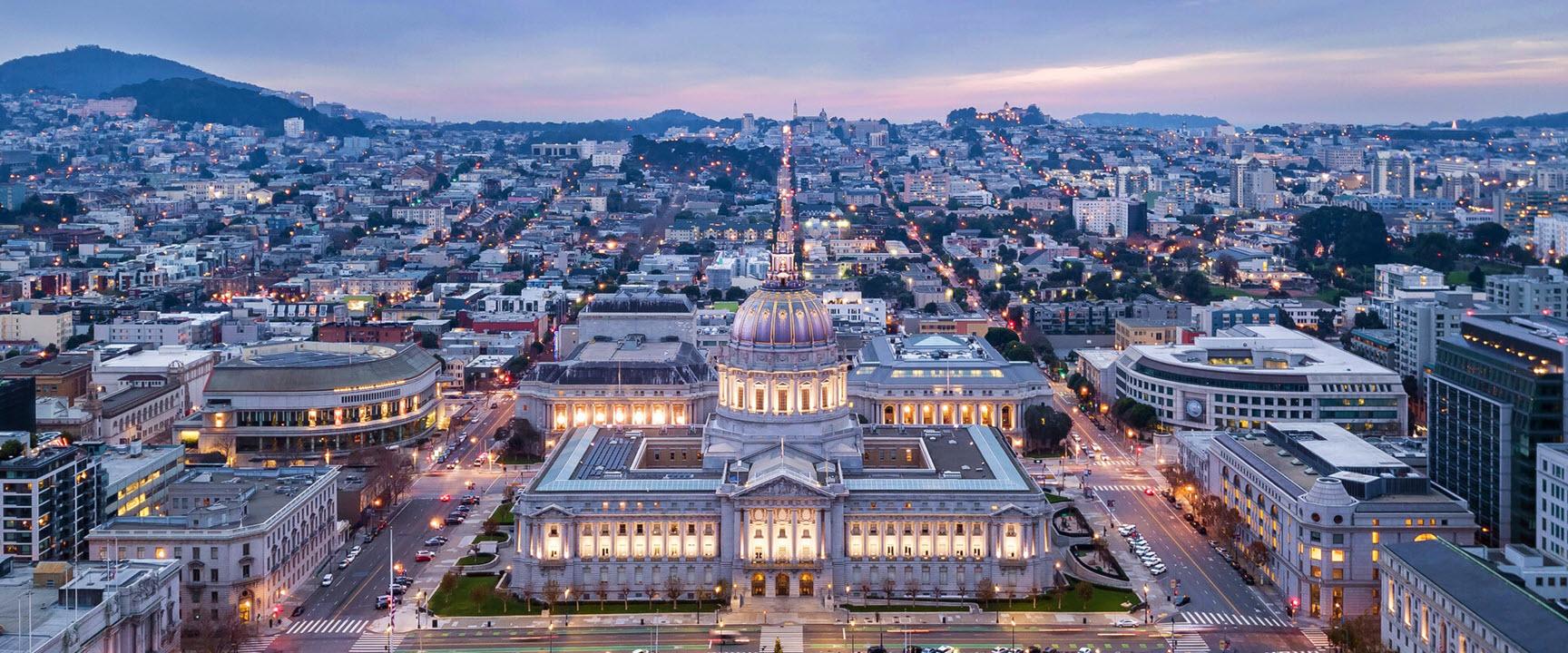 panoramic view of civic center plaza and City Hall in the evening.