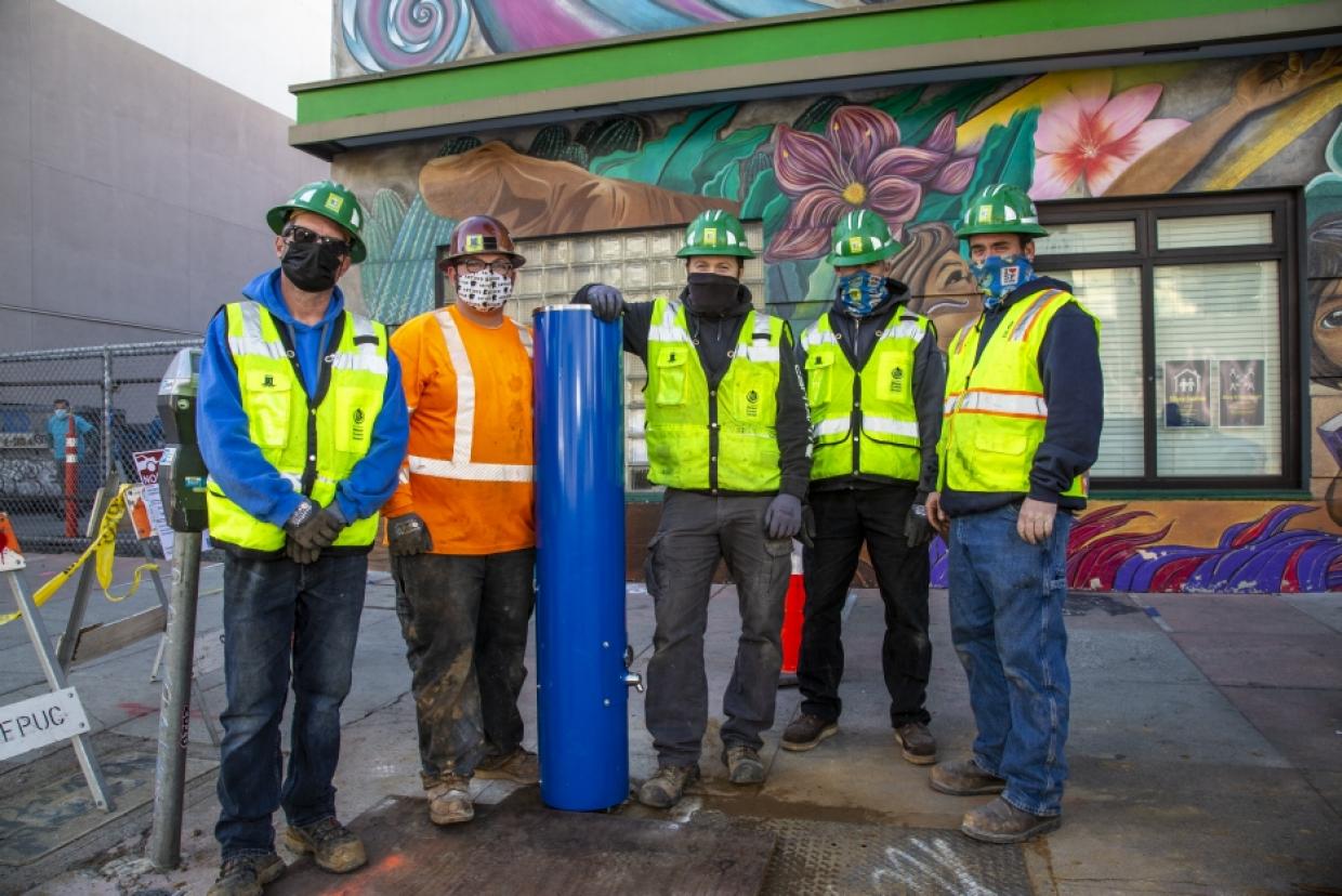 installation crew standing with new tap station