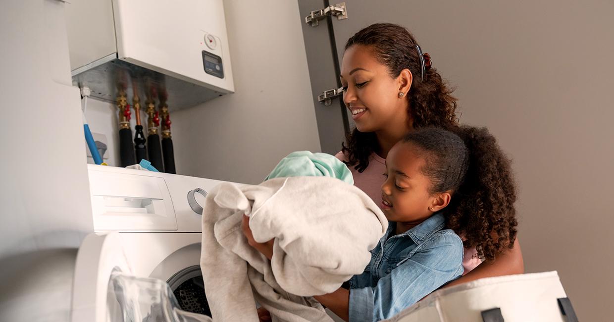 Mother and daughter doing laundry together