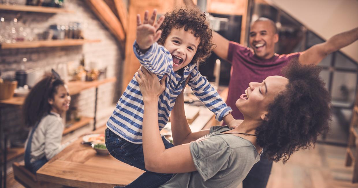 Family celebrating around a kitchen table.