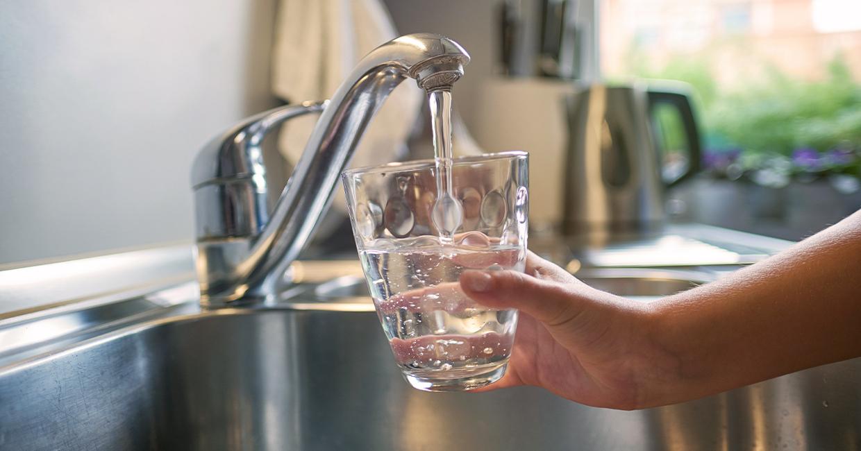 Pouring tap water from the faucet