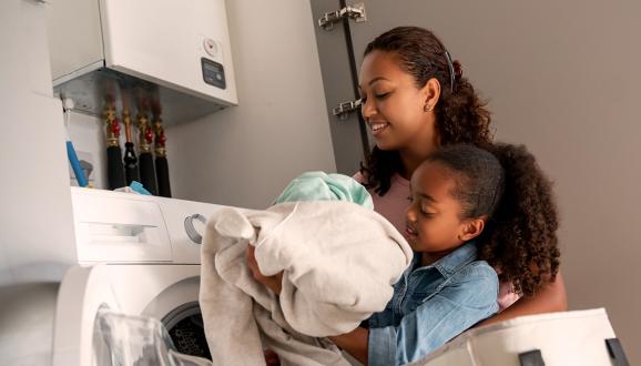 Mother and daughter doing laundry together