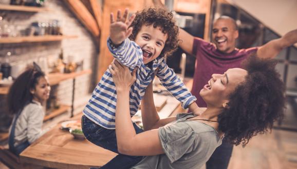 Family celebrating around a kitchen table.