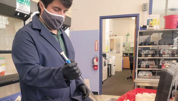 Tim Paez working in a lab.