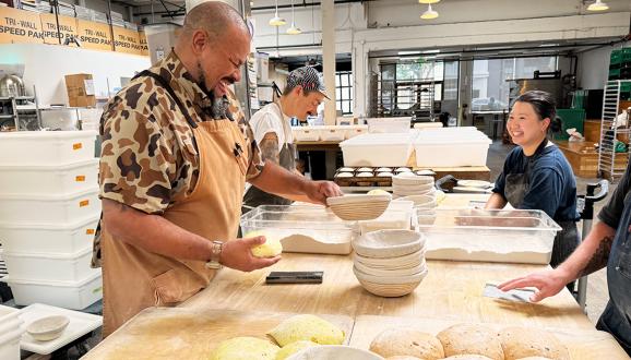 Azikiwee Anderson or Z and his staff all smiles while making bread.