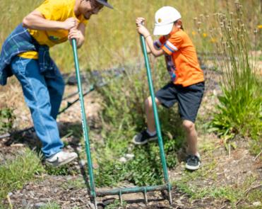 Community members celebrating PODER’s annual corn planting at Mama Earth Day Event in 2023.